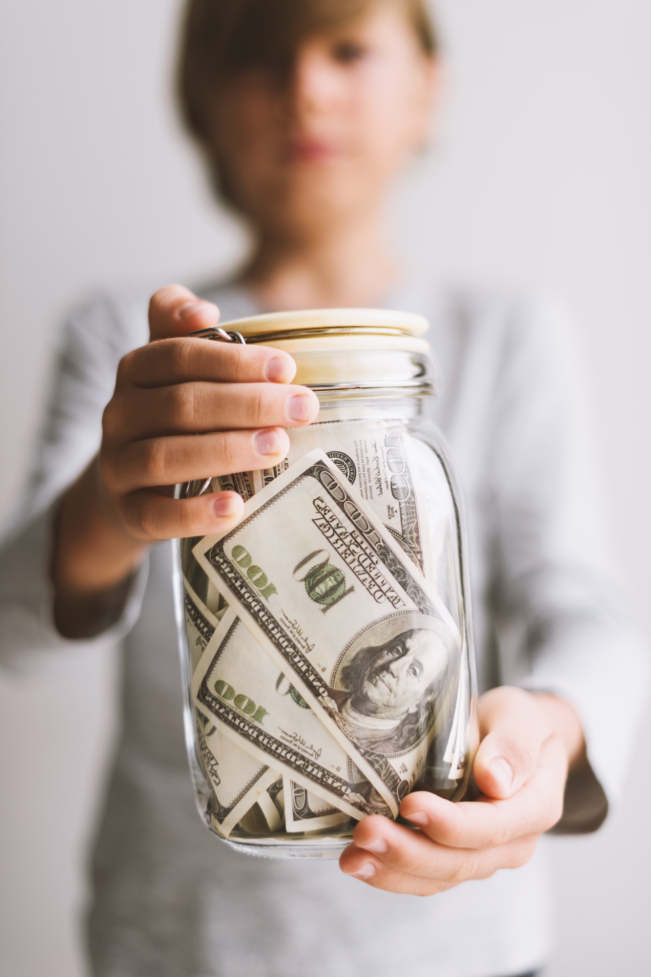 Kid save money. Put money in a piggy bank